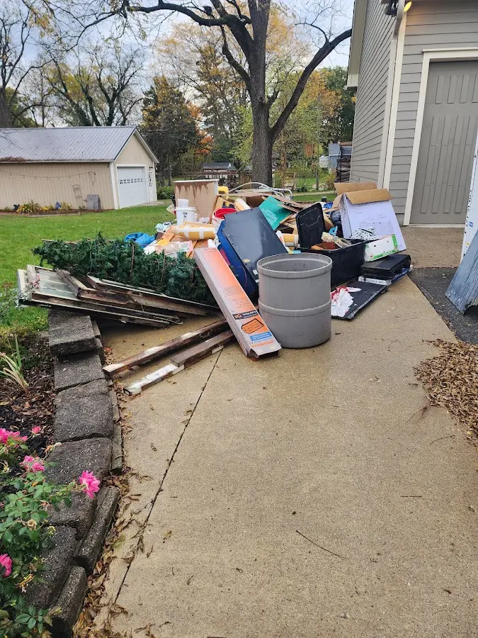 Dumpster being loaded with debris for Estate Cleanout Dumpster Rental in San Tan Valley